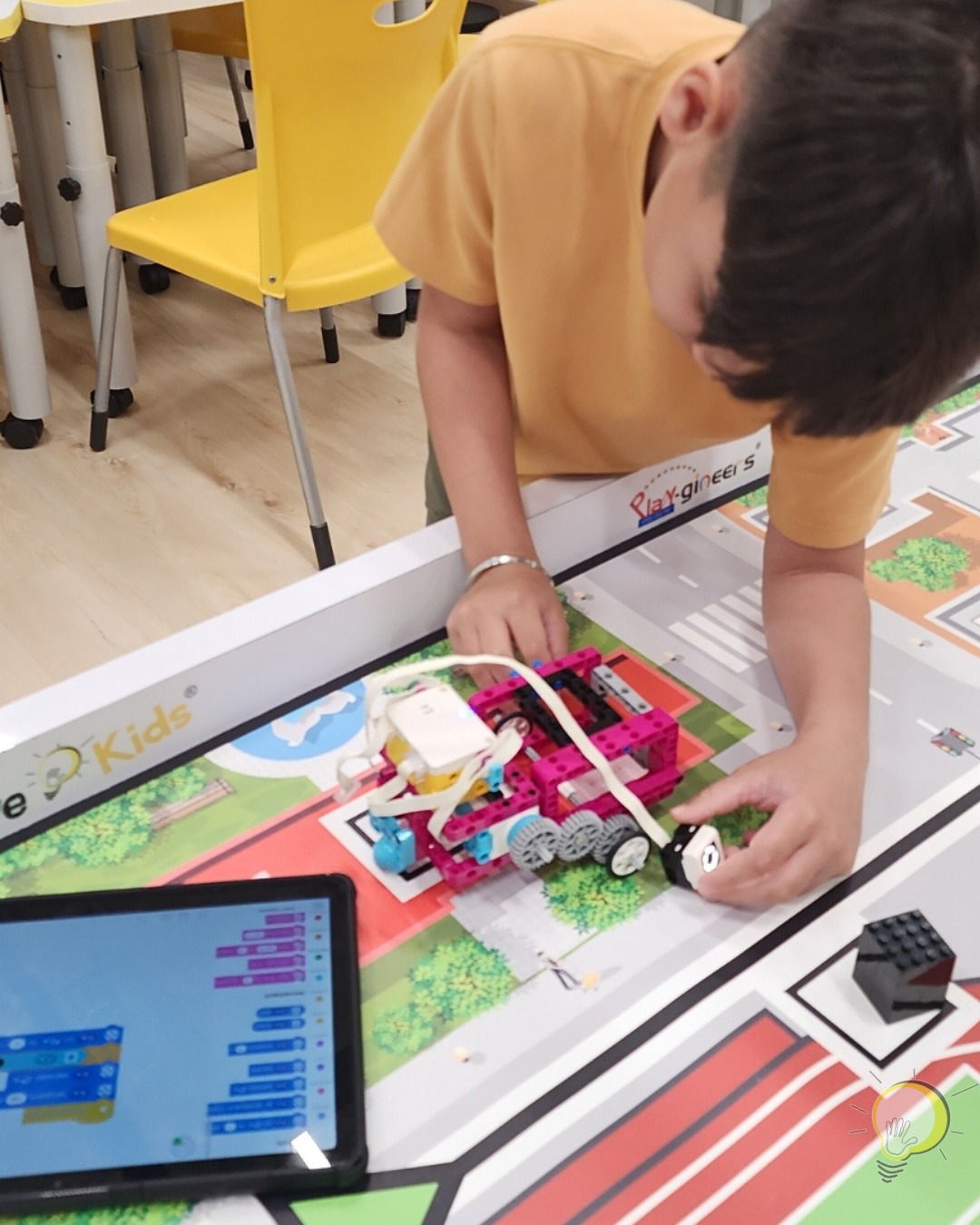 Children engaged in a hands-on robotics building and coding session