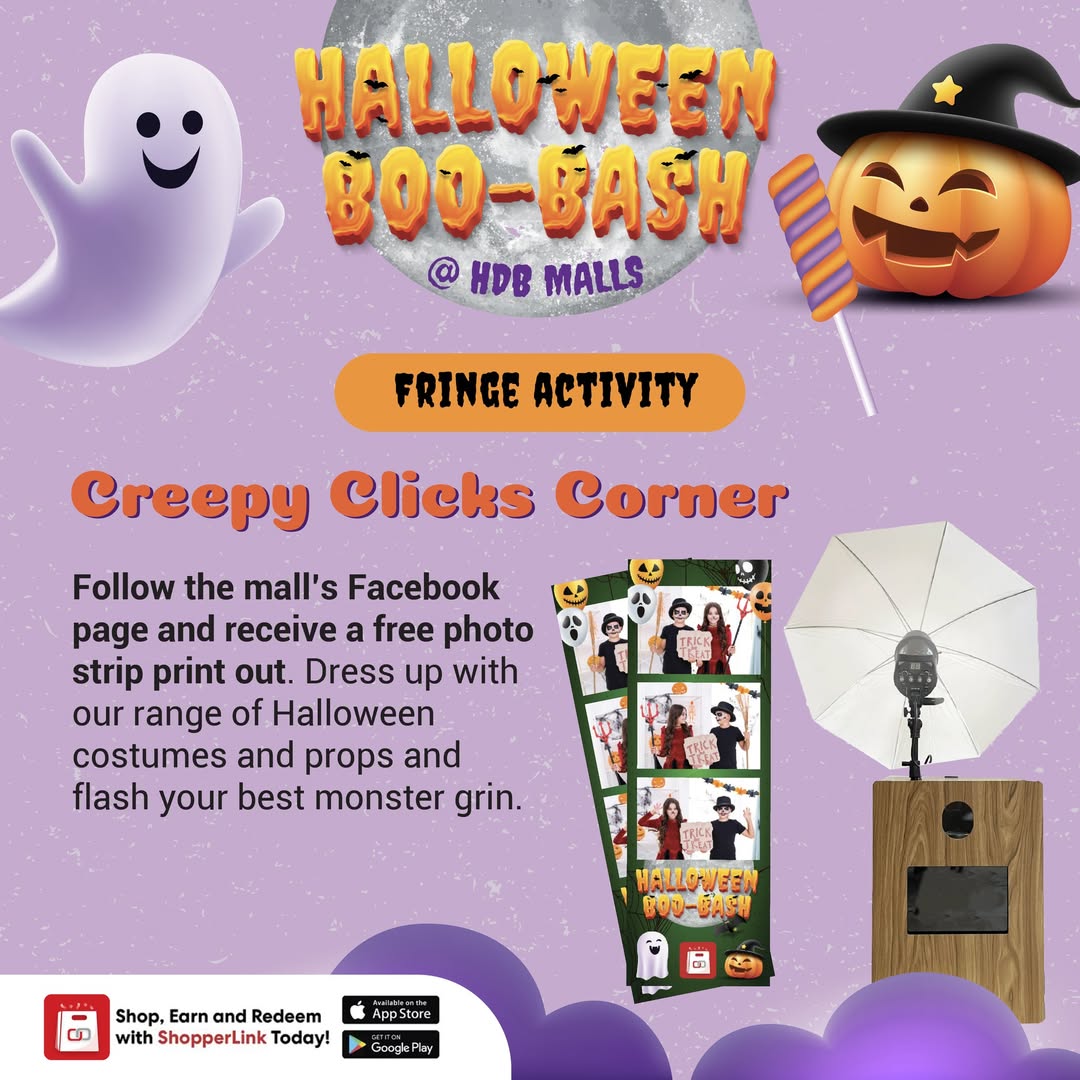 A Halloween-themed photo booth setup with festive decorations and props.